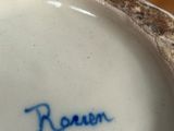 a close up of a vase with a name written on it