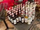many bottles of alcohol sitting on a table in a store