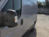 a silver van that is parked in a parking lot