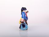 a small figurine of a man carrying a bag