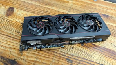a close up of a video card sitting on top of a wooden table