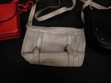several purses are lined up on a black surface