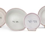 five plates with different designs on them on a white surface