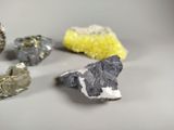 several different colored crystals are arranged on a white surface