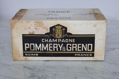 an old box of champagne sitting on top of a marble counter