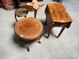 three tables and two stools sitting on the floor