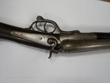 an old gun that is laying on top of a table