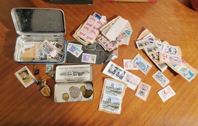a suitcase full of stamps and money sitting on a table