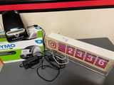 a cell phone sitting on top of a box next to a charger