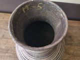 a small vase that is sitting on a wooden table
