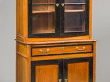 a wooden cabinet with glass doors and drawers on top