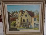 an oil painting of a house in a frame on a table