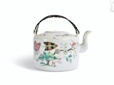 a white tea pot with a butterfly design on it
