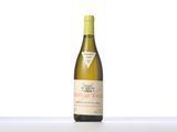 the bottle of white wine is sitting on the table