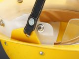 a yellow boat with a black strap and a watch in it