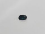 a close up of a black diamond on a white surface