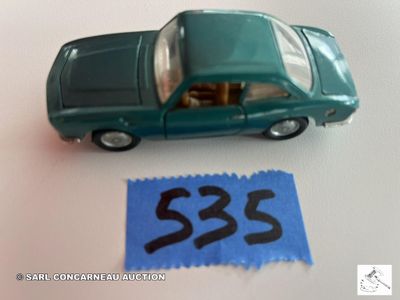 une petite voiture miniature avec une étiquette de prix à côté