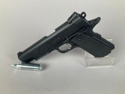 the gun is next to a lighter on a clear stand