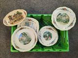 four plates in a green crate with a picture on them
