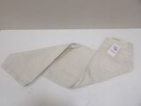pair of white pants on a white table with a tag