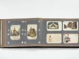 an open book with pictures on it on a white surface