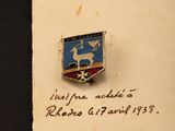 an old picture of a badge on a piece of paper