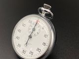a close up of a stopwatch on a black surface
