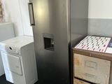 a refrigerator and a washing machine in a room