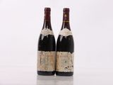 two bottles of wine sitting next to each other on top of a table