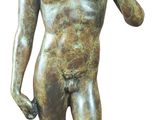 bronze statue of a boy holding a bird on a white background