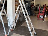 two ladders that are sitting in the middle of a room