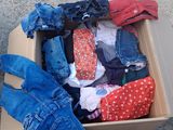 a box full of clothes sitting on the ground