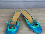 a pair of blue shoes on a wooden table