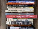 many books in a cardboard box on the floor
