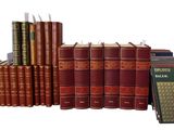 a lot of books that are stacked on top of each other