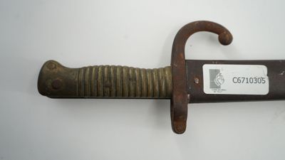 a knife that is on the wall with a tag on it