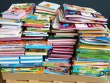 many books stacked on top of each other on a pallet