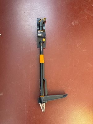 a tool that is laying on the floor next to a wall