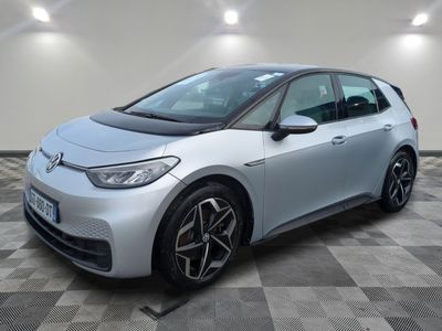 a silver car parked in a garage with a checkered floor