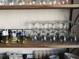 a shelf with many glasses and bottles on it