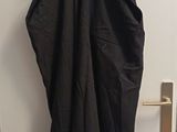 a black dress hanging on the door of a room