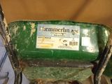 a green wheelbarrow with a sticker on it
