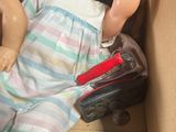 a doll in a box with two dolls inside of it