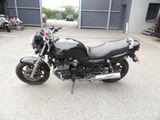 a black motorcycle parked in front of a building