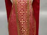 a close up of a red and gold vest on a mannequin