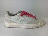 white and pink sneakers with pink laces on them on a white surface