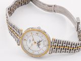 a silver and gold wrist watch with a white dial