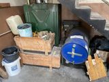 a stack of barrels and crates in a garage