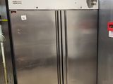 two stainless steel refrigerators in a kitchen with tile flooring