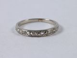 a close up of a wedding ring on a white surface